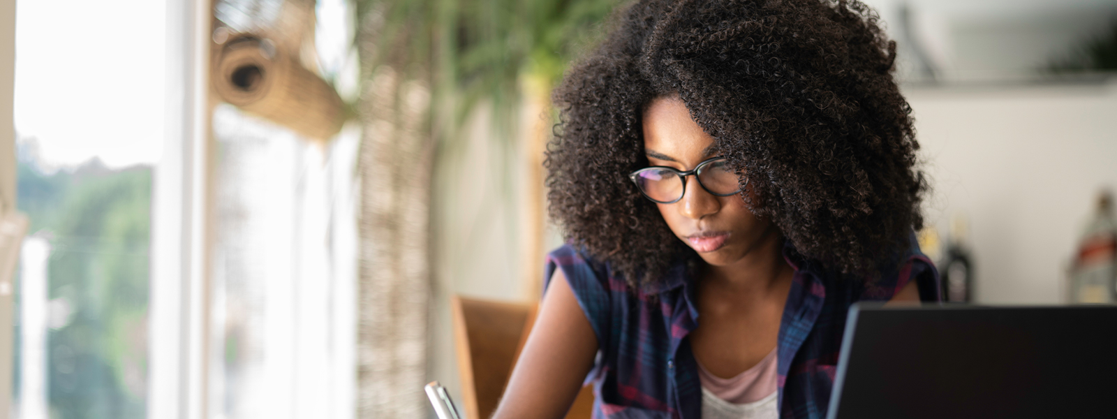 Teenaged girl studying at home.