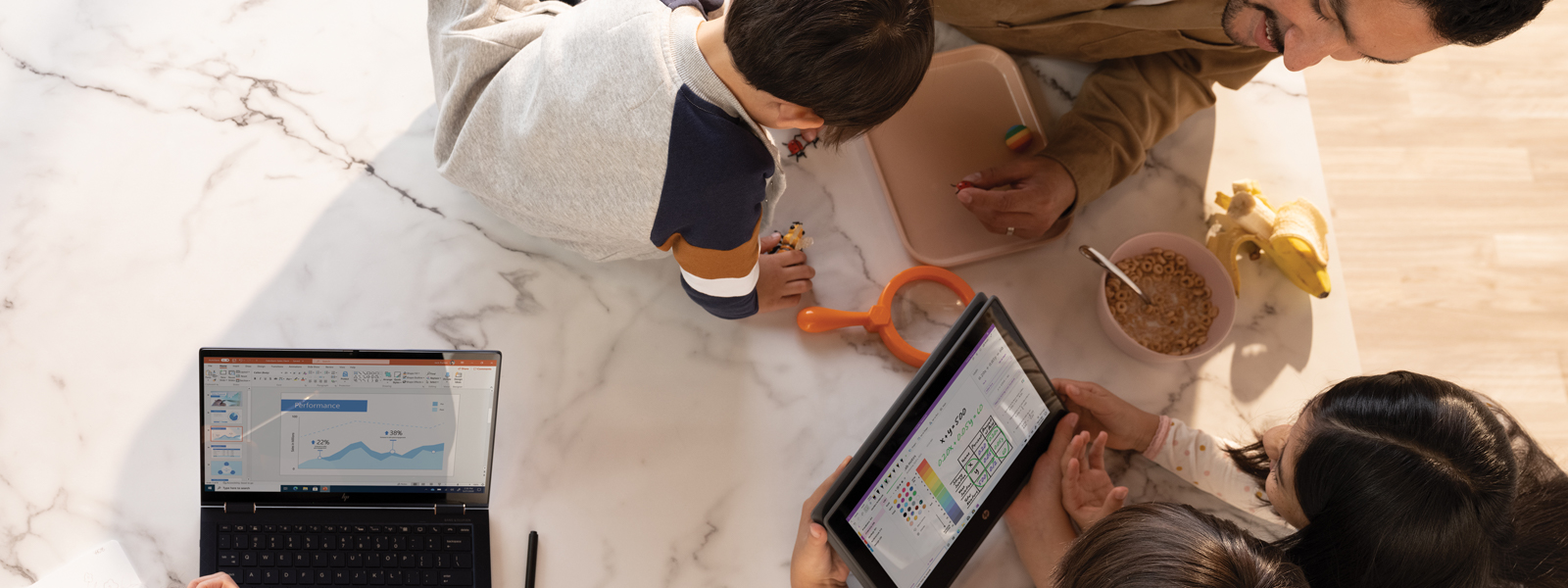A family working and learning remotely around their kitchen table. The mother has a PowerPoint file open on an HP Elite Dragonfly. The father and two older children are looking at OneNote Math Assistant on an HP Probook x360.