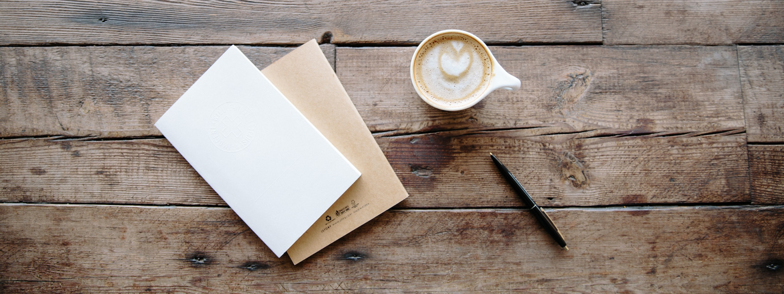 A photo of a notebook with coffee