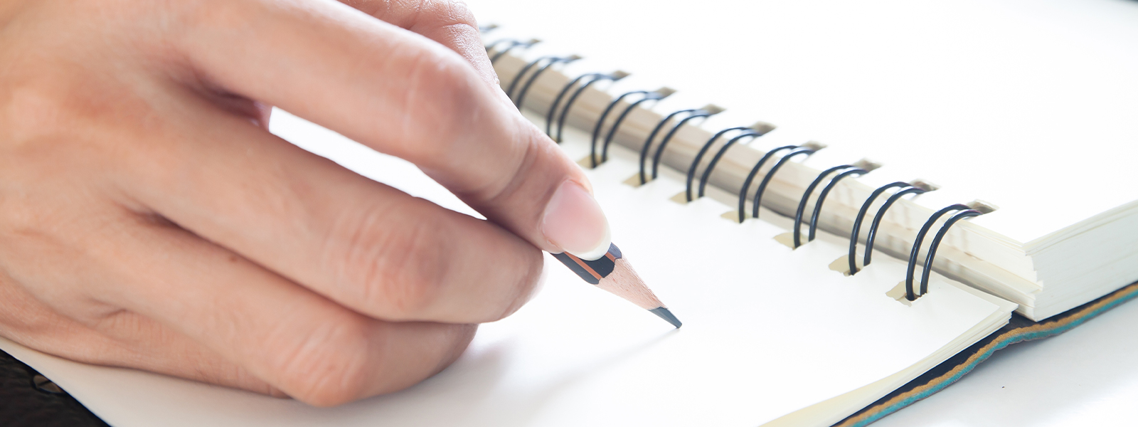 A woman writing in a journal.