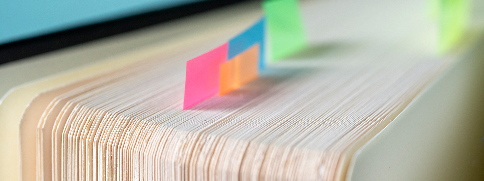 Open book with sticky markers on its pages.