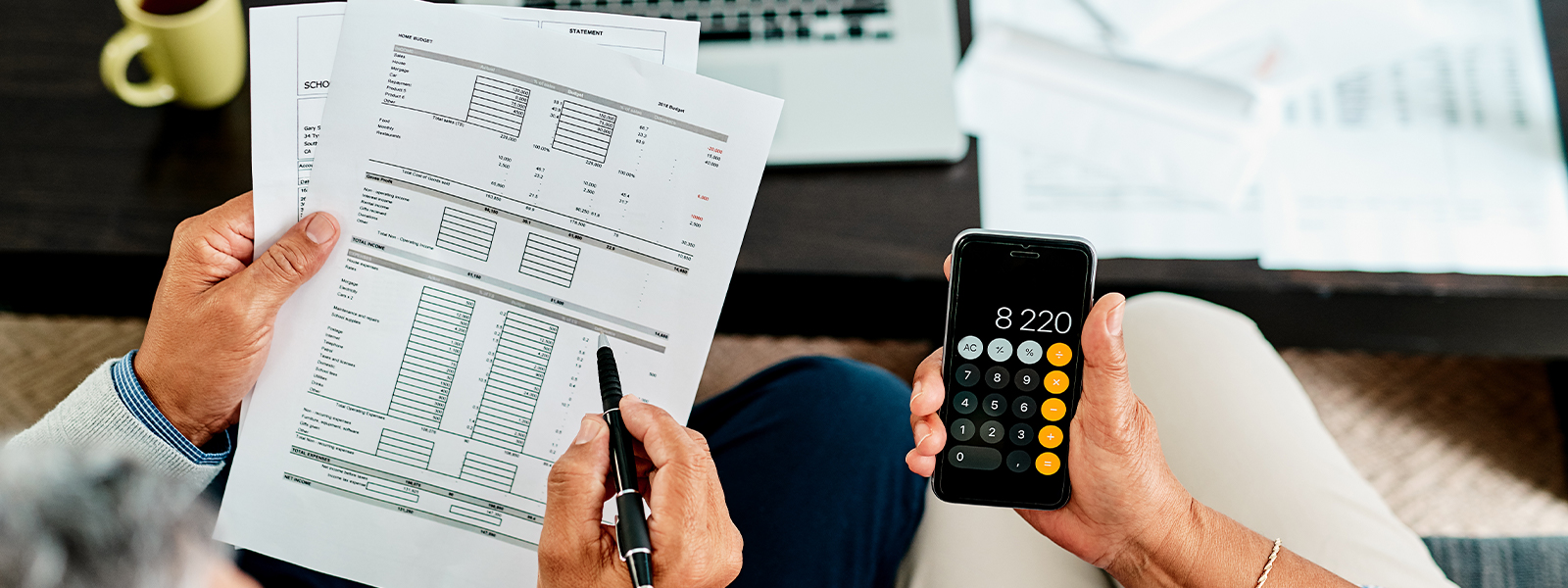 A couple calculating their finances together at home and balancing their numbers.