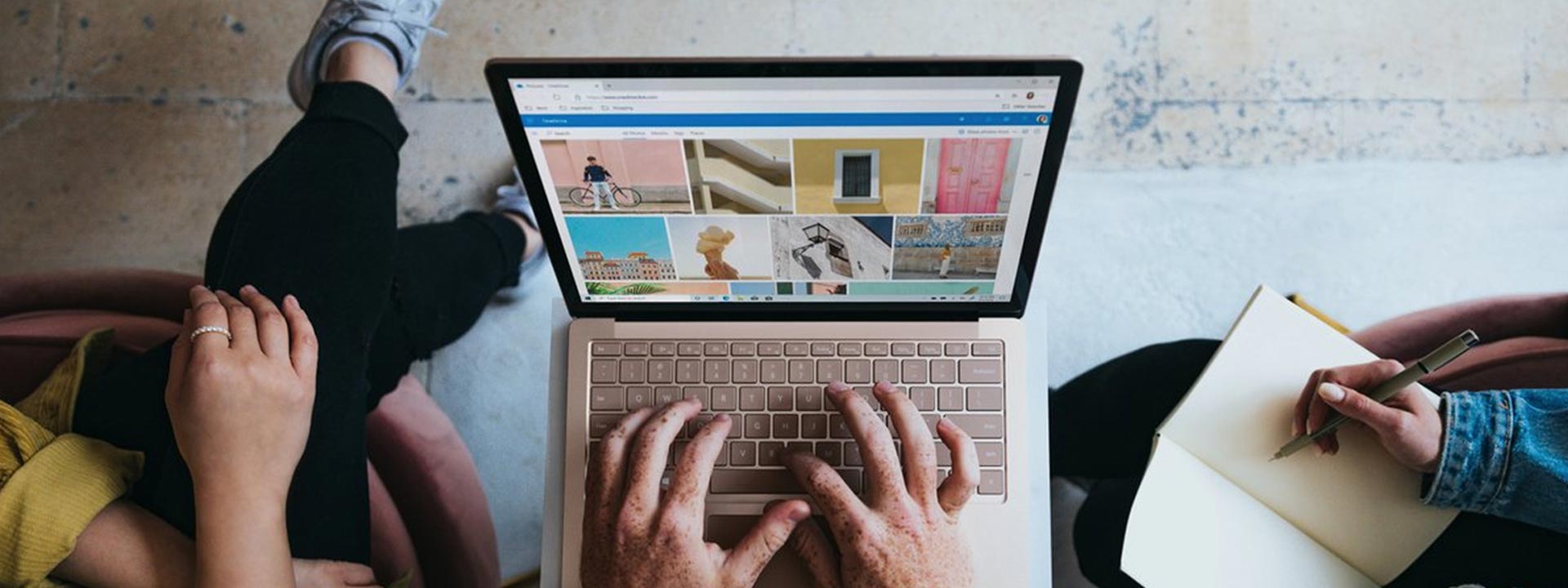 a person using a laptop and a person writing in a journal