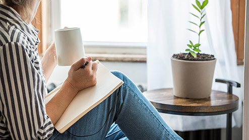 a young woman taking a break from technology and writing