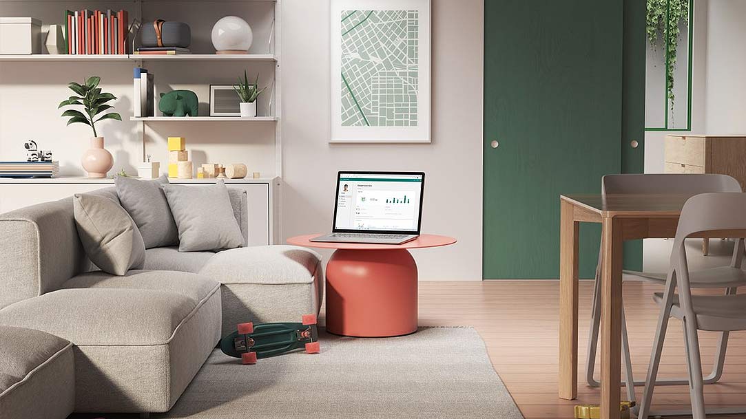  a living room with Microsoft 365 PowerPoint slides on the laptop screen