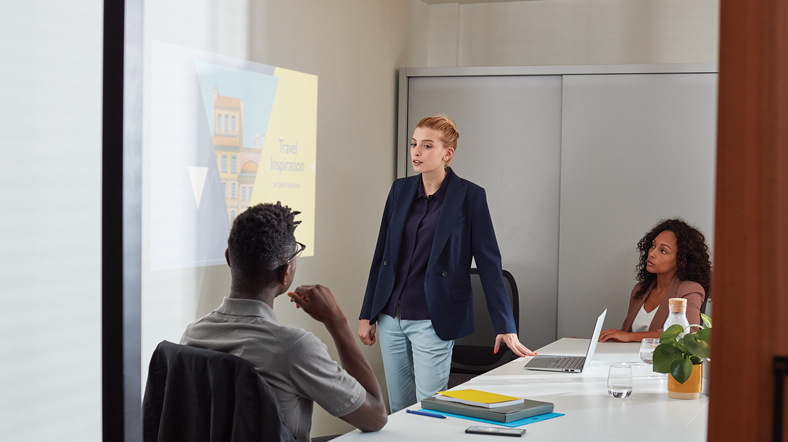 a young adult student presenting in PowerPoint on Dell Inspiron 7000.